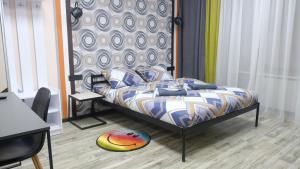 a bedroom with a bed with a colorful comforter at Uneed Rooms M1 in Kyiv
