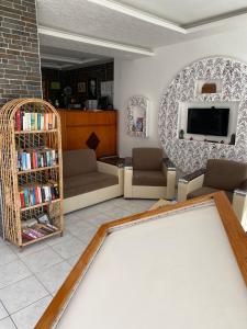 a living room with a pool table and a tv at Sevgi Hotel Kalkan in Kalkan