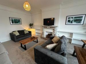 a living room with two couches and a fireplace at Ashbrook Stert St 5 bedroom property in Abingdon