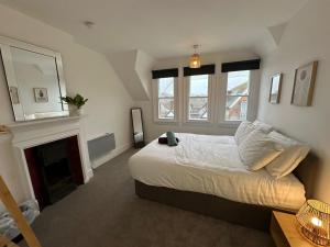 a bedroom with a large bed and a fireplace at Ashbrook Stert St 5 bedroom property in Abingdon