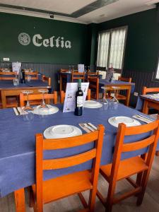 a dining room with a table with a bottle of wine at Posada Celtia in Vigo
