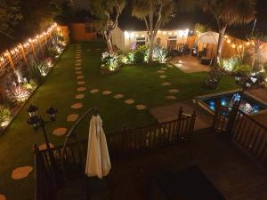 an overhead view of a garden at night with an umbrella at Appletorre House Holiday Flats in Torquay