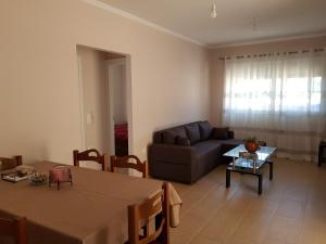 a living room with a couch and a table at Dimas House in Kanallaki