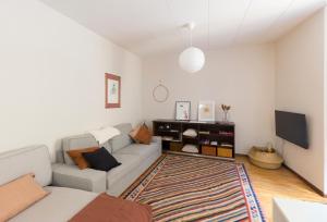a living room with a couch and a tv at Casa Parravicini in Sondrio