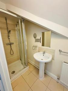 a bathroom with a sink and a shower at Elm Vale Lodge in Liverpool