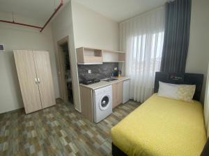 a small room with a bed and a washing machine at Tempo Florya Otel in Istanbul