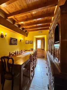 a dining room with a large wooden table and chairs at Casa Rural El Torrejon in Arenas de Cabrales