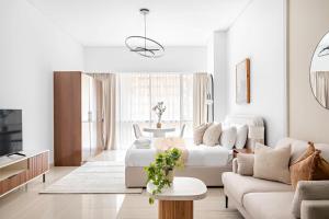 a living room with a couch and a table at Silkhaus Modern Studio Near Silicon Central Mall in Dubai