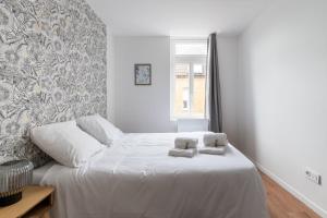 Ένα ή περισσότερα κρεβάτια σε δωμάτιο στο Maison Rivero - Welkeys +7 φωτογραφίες