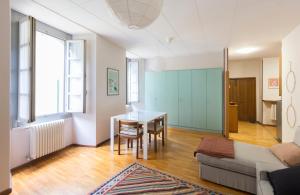 a living room with a table and a couch at Casa Parravicini in Sondrio