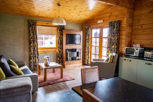 a living room with a couch and a table at Ingliston Country Club Hotel in Bishopton