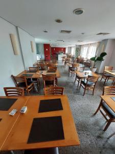 a dining room with wooden tables and chairs at Flat Barra First - Morada Stay in Rio de Janeiro