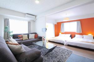 sala de estar con cama y sofá en Ishiki - Best location 2 min HiroshimJR station, Up to 10 ppl en Hiroshima