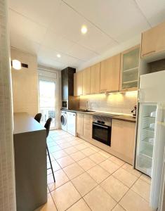 a kitchen with a refrigerator and a counter in it at Apartaments Terraza - Santa Maria in Roses