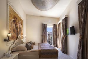 a living room with a couch and a large window at Heritage Hotel Life Palace in &Scaron;ibenik