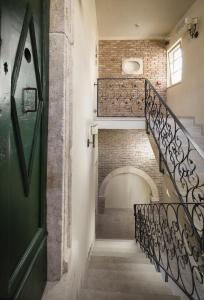 a staircase in a building with a green door at Heritage Hotel Life Palace in Šibenik