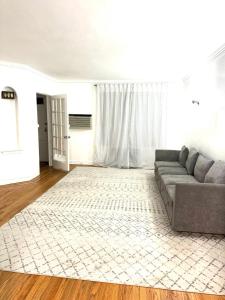 a living room with a couch and a rug at Stay Rego Park in Rego Park