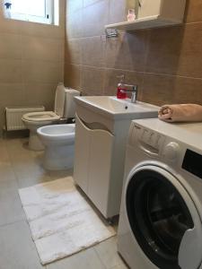 a bathroom with a washing machine and a sink at Duplex in Chişinău