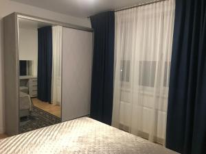 奇西瑙的住宿－Duplex，一间带大镜子和床的卧室