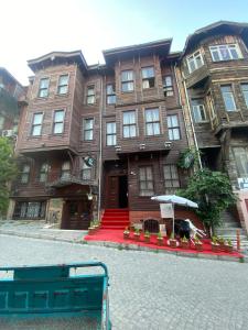 a large brown building with a table in front of it at Nuray Hotel in Istanbul