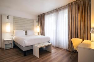Postel nebo postele na pokoji v ubytování Le Grand Hotel