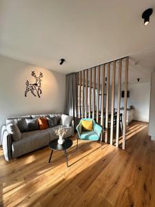 a living room with a couch and a table at Soca Valley Suites in Bovec