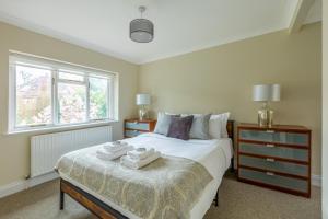 a bedroom with a bed with two towels on it at Lovely 2BR in peaceful Hampstead, NW London in London