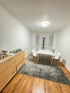 a dining room with a table and chairs at Stay Rego Park in Rego Park