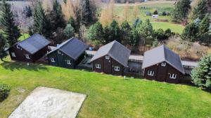 an aerial view of a group of houses on a hill at Stanica pod Zadzierną Domki całoroczne in Lubawka