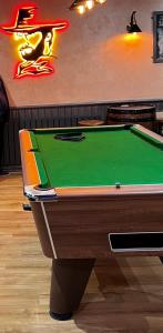 a pool table in a bar with a green at The Barrington Hotel in New Barnet