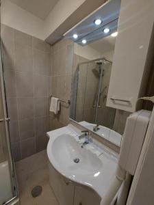 a bathroom with a sink and a mirror at Hotel Positano Suite in Rome