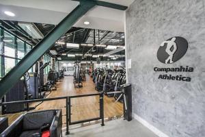 a gym with rows of exercise equipment on the wall at Flat Barra First - Morada Stay in Rio de Janeiro