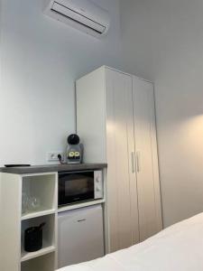 a kitchen with a white cabinet and a microwave at Apartment Loftas13-6 in Kretinga