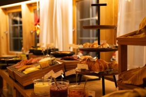 a table topped with different types of bread and pastries at Sorrisniva Arctic Wilderness Lodge in Alta