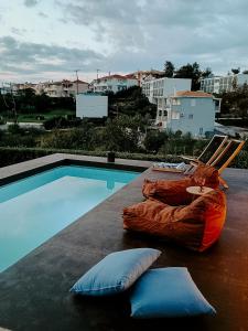 a hammock sitting next to a swimming pool at CASA DI NONNA ANNY in Porto Heli