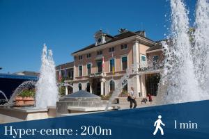 a water fountain in front of a building at Homey Cute - Parking inclus - Proche Geneve in Annemasse