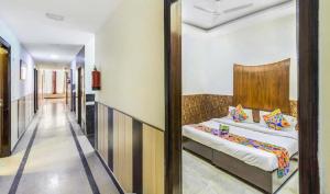a bedroom with a bed and a mirror at Aerocity Hotel Zindal Plaza at Delhi Airport in New Delhi
