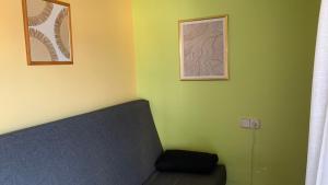 a room with a couch and two pictures on the wall at Precioso ático en Playa América a 200 metros de la playa in Nigrán