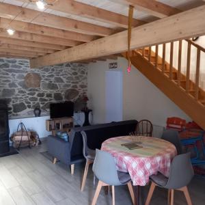 a living room with a table and a couch at Les maisons d'Ustou. in Ustou