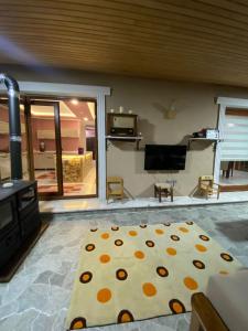 a living room with a polka dot rug on the floor at Özyurt Villa in Araklı