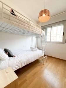 a bedroom with a bunk bed and a ladder at Apartamento La Sal Cubelles in Cubelles