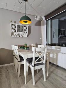 uma sala de jantar com uma mesa branca e cadeiras em Pusteblume em Altenau