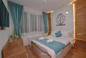 En eller flere senge i et værelse på Хотел Терра Роза