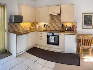 a kitchen with white appliances and a table at Bentinck in Legbourne