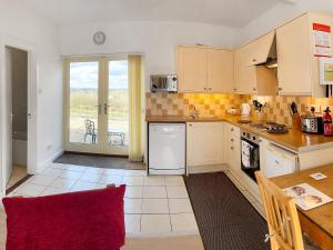 a kitchen with white appliances and a table with a table at Bentinck in Legbourne