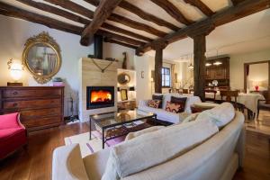 a living room with a couch and a fireplace at The Basque Experience by Fidalsa in Ochandiano