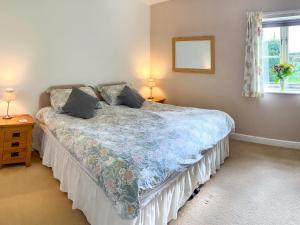 a bedroom with a bed and two lamps and a window at Chaplin in Legbourne