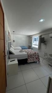 a bedroom with a bed and a chair in it at Israel flat tambau 106 in João Pessoa