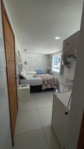 a small bedroom with a bed and a table at Israel flat tambau 106 in João Pessoa