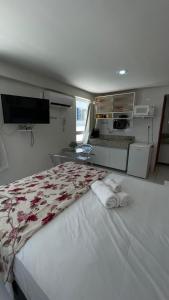 a bedroom with a large bed with towels on it at Israel flat tambau 106 in João Pessoa